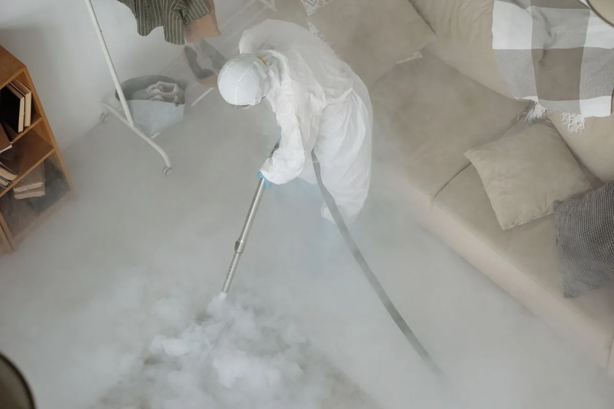 Biohazard cleanup technician in protective equipment, Coralville, IA